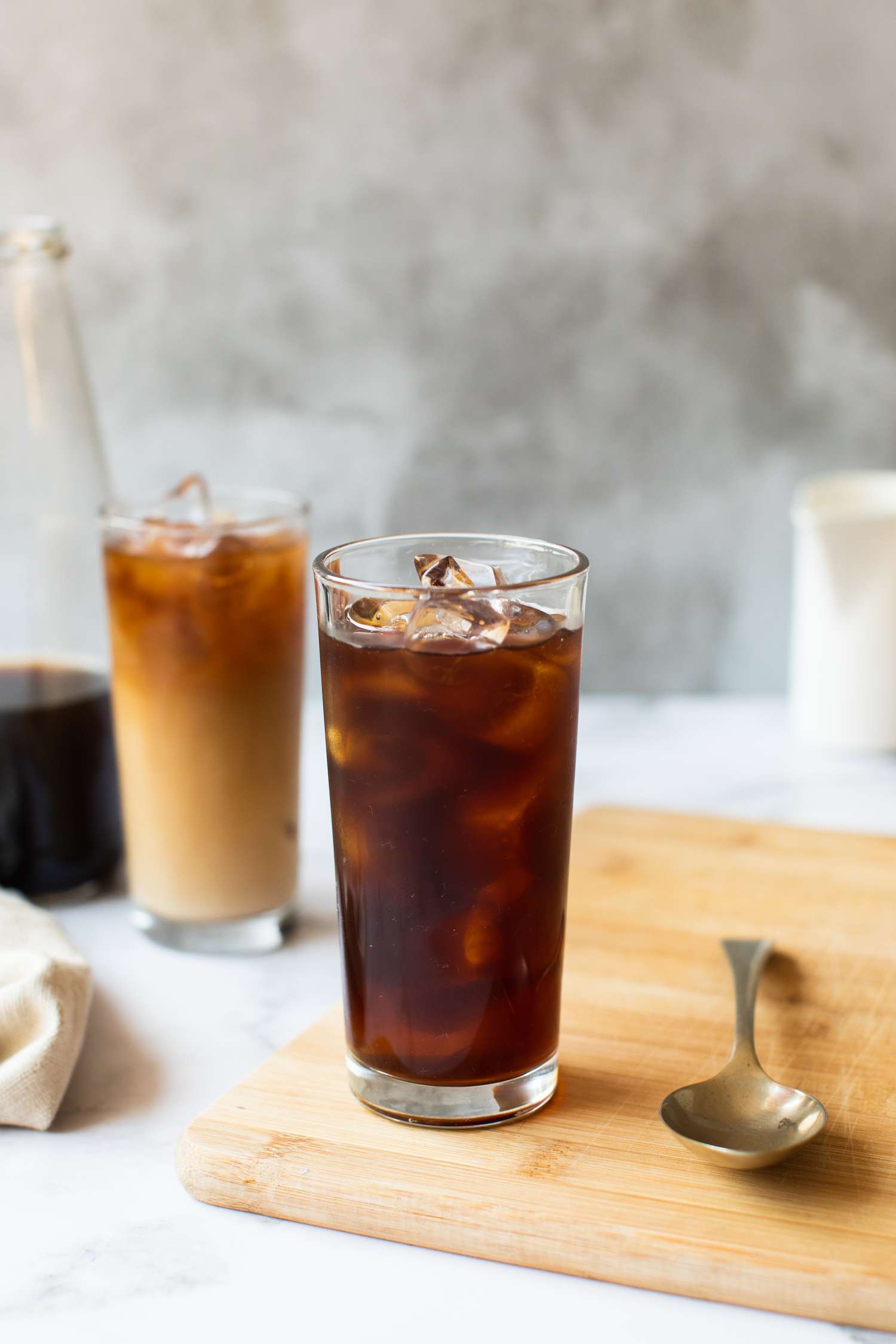 Two Glasses of Cold Brew Coffee, One without Cream and One with Creamer