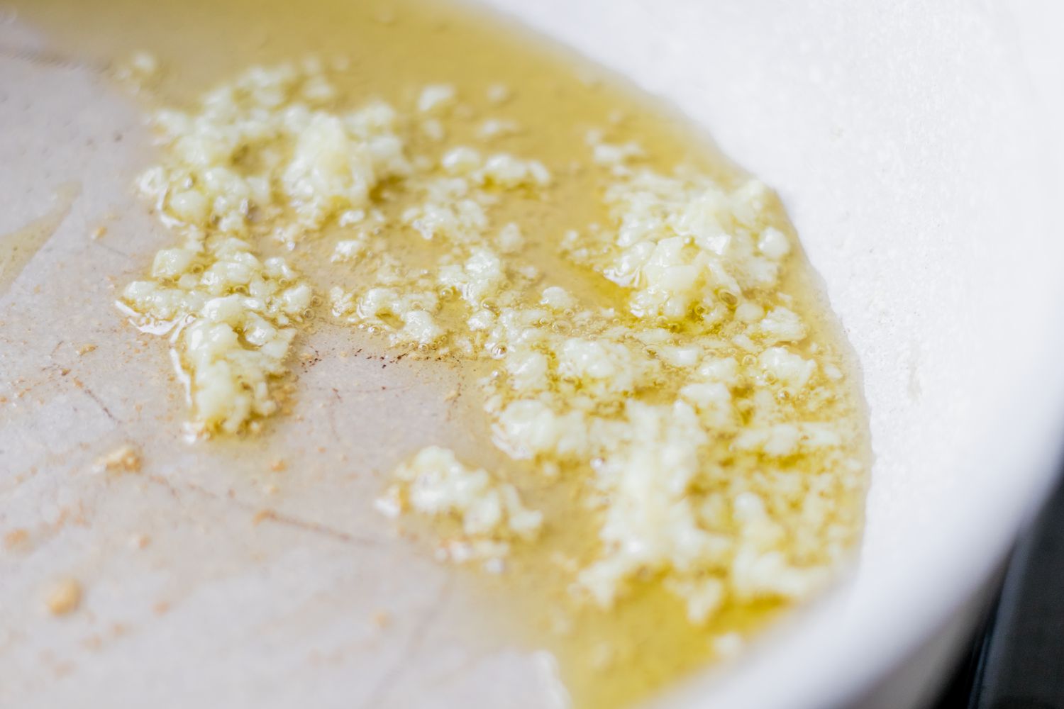 Garlic cooking in oil in a pan