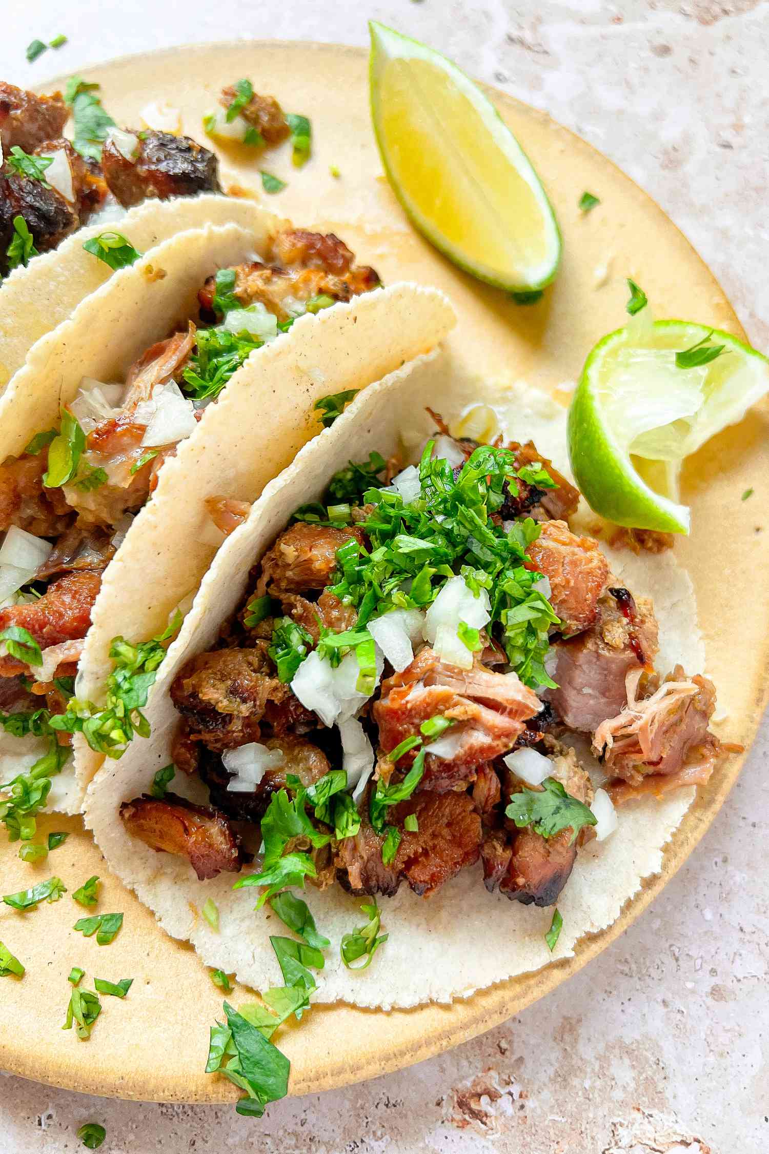 Carnitas Tacos with Chopped Cilantro, Diced Onions, and Lime Wedges