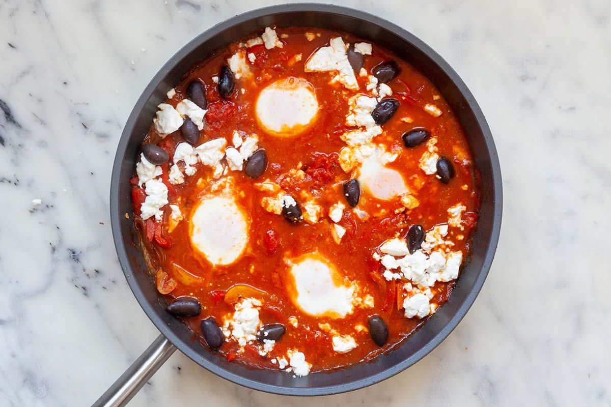 Olives added to the skillet to show How to Make Shakshuka.