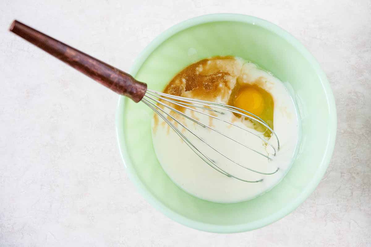 A bowl of milk, eggs, and vanilla waiting to be whisked together