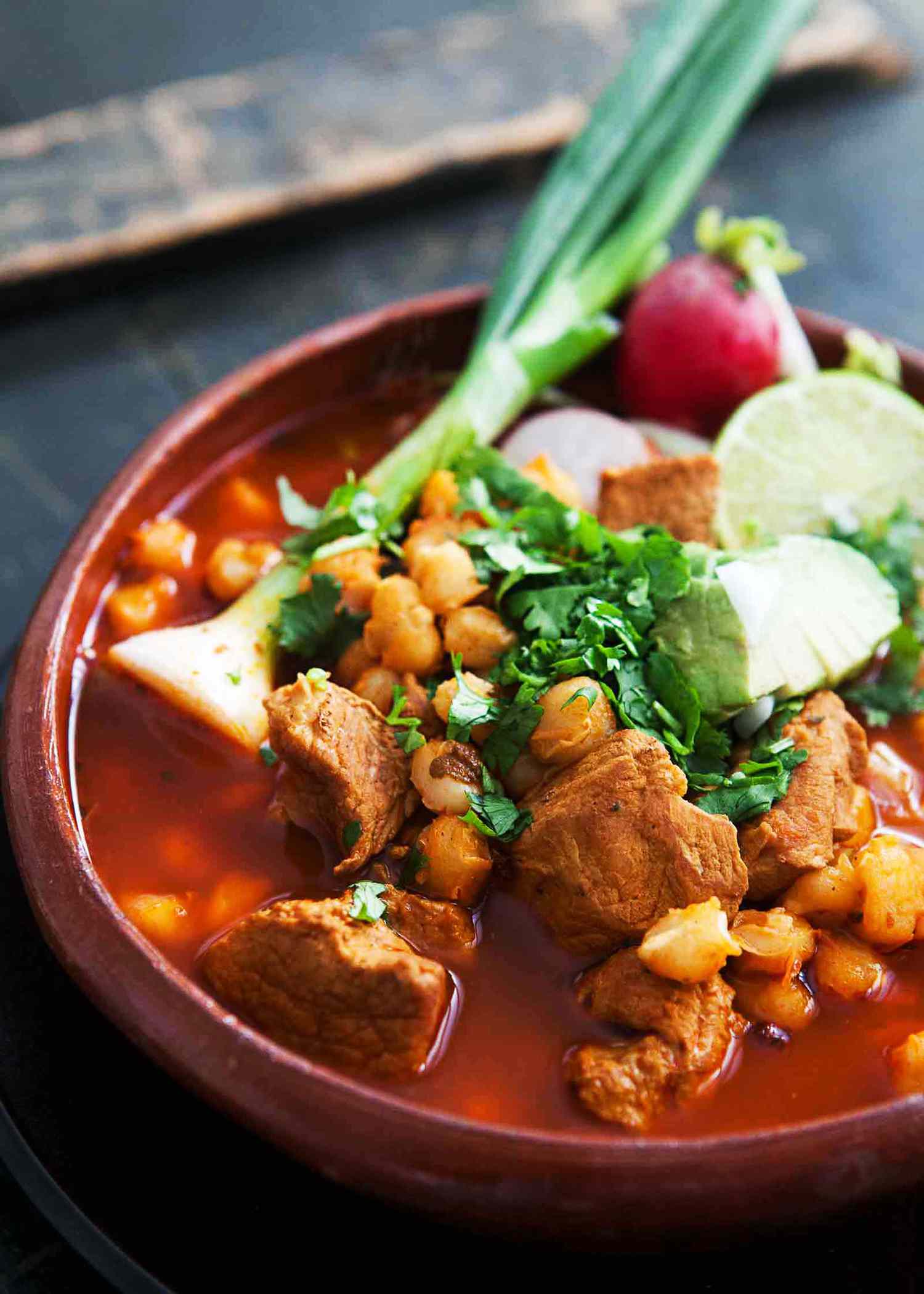 Pork Pozole with Red Chilies in a red bowl