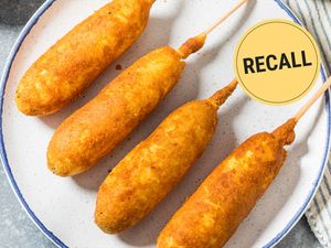 Four corndogs on a plate with a recall notice symbol
