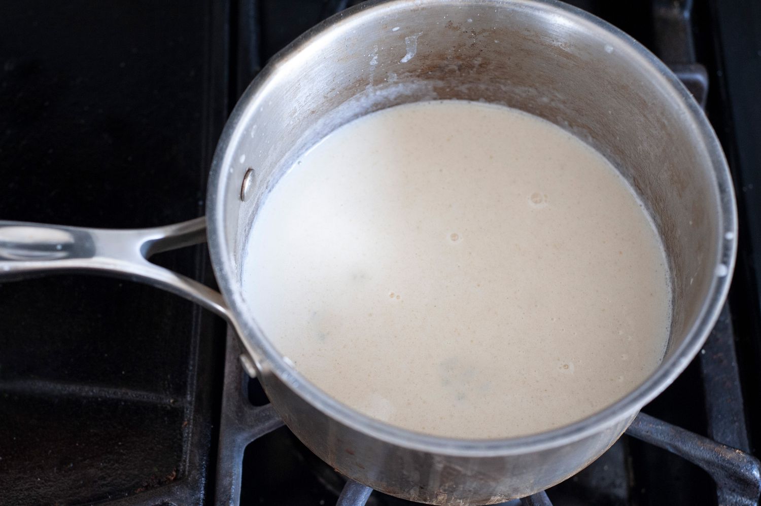 Add milk to roux to make bechamél.
