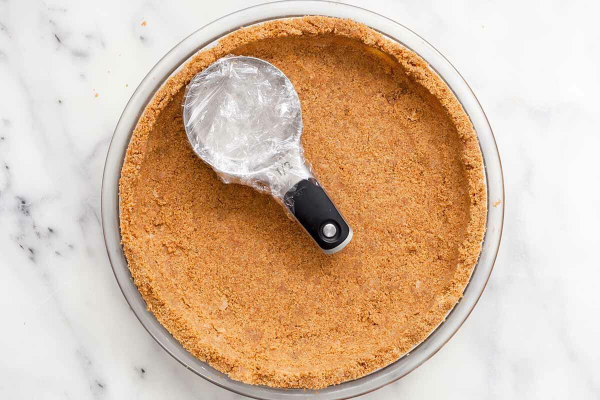 tamp down graham cracker crust recipe with measuring scoop