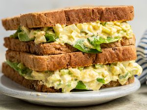 Two egg salad sandwiches stacked on top of each other
