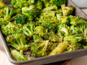 seasoned roasted broccoli florets on a sheet pan
