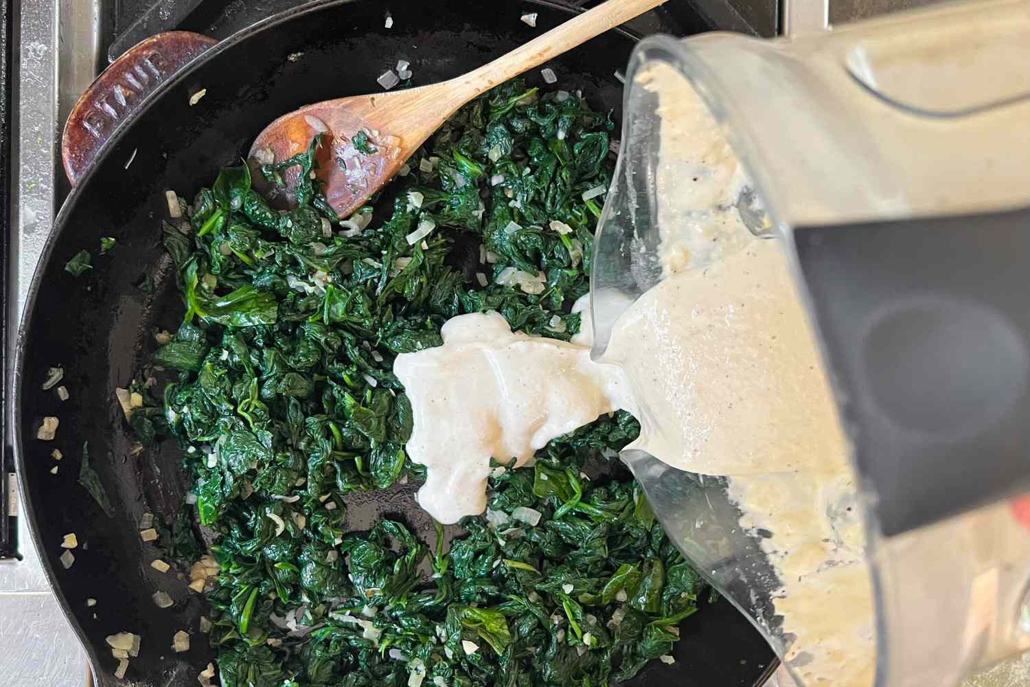 Sauce Added to Spinach in Skillet