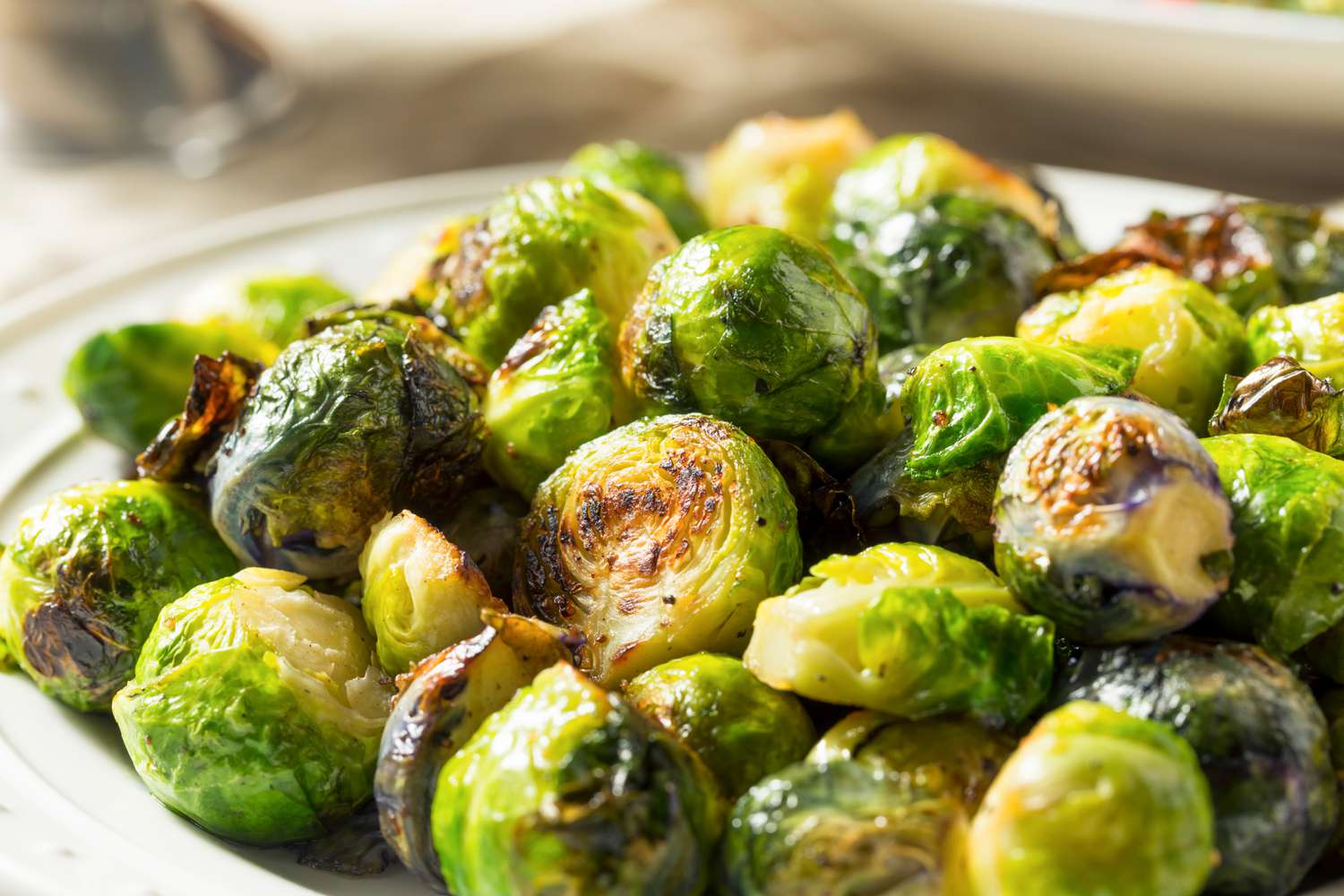 Roasted whole brussels sprouts on a white plate