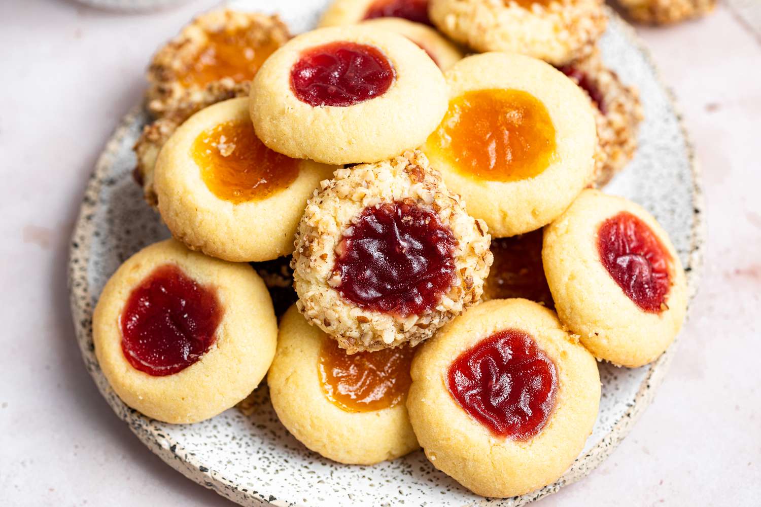 Pile of classic thumbprint cookies on a platter.