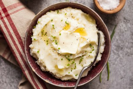 Make Ahead Mashed Potatoes Slow Cooker potatoes in a dish with butter and a napkin