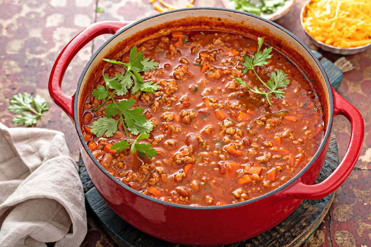 A pot of chili with cilantro garnish on top