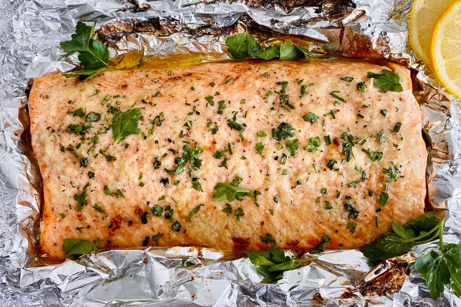An overhead of a cut of garlic butter roasted salmon