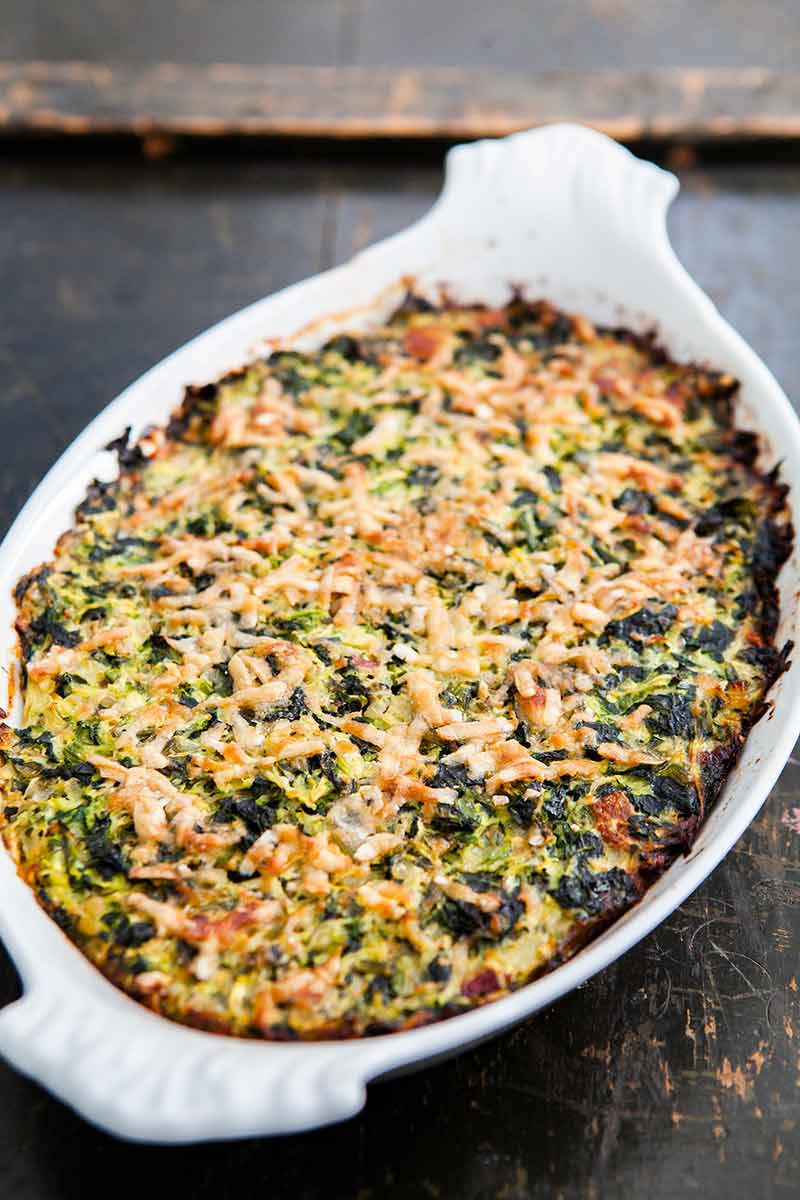zucchini spinach gratin in white casserole dish