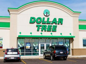 The exterior of a Dollar Tree storefront with parked cars in front
