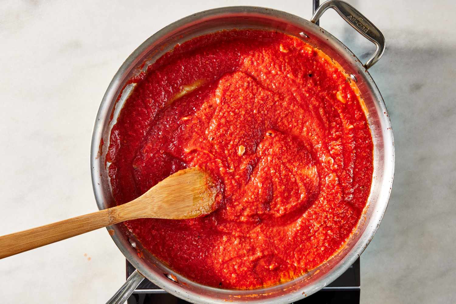 tomato sauce added to the pot for pasta alla norma recipe