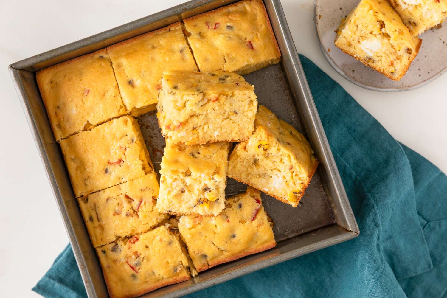 Baking dish with sliced cornbread pieces a few stacked on top