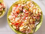 Tomato cracker salad in a bowl with a serving spoon
