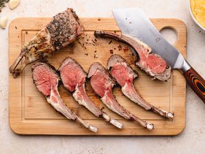 Rack of lamb cut into chops on cutting board