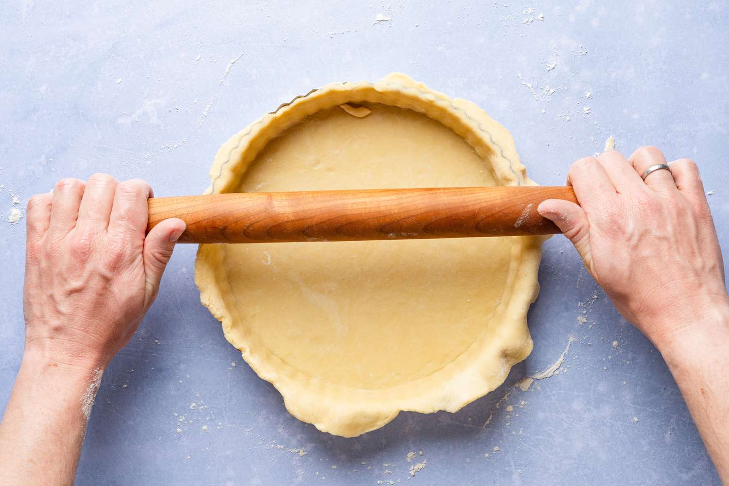 rolling pin rolled edges of tart pan to create clean tart edges for cornflake tart recipe