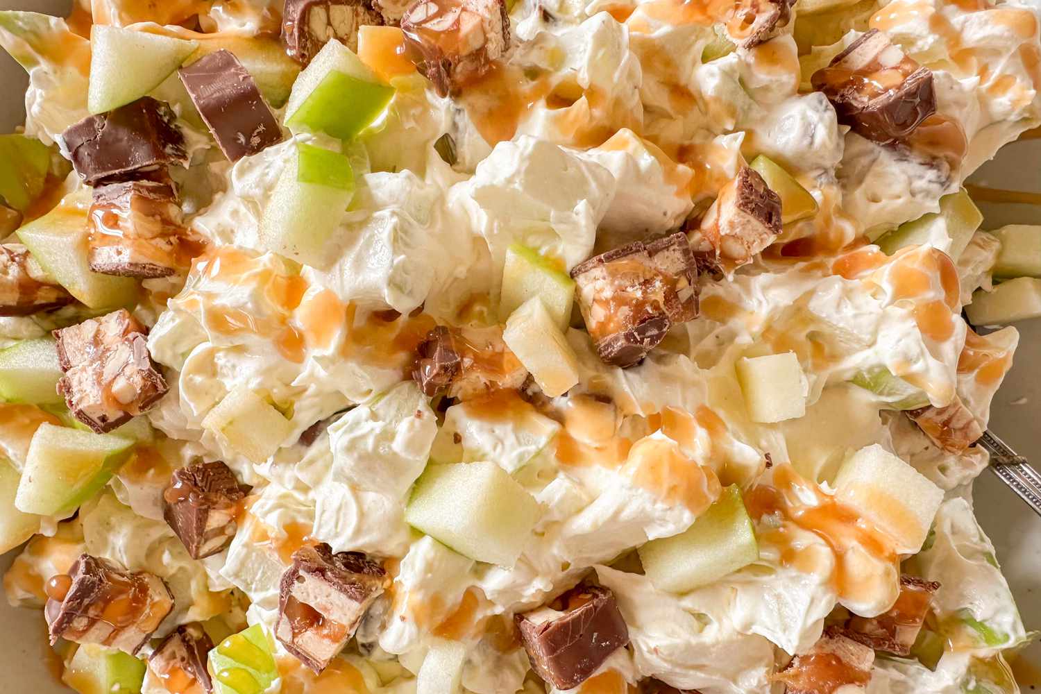 Snickers salad with chopped apples and caramel drizzle