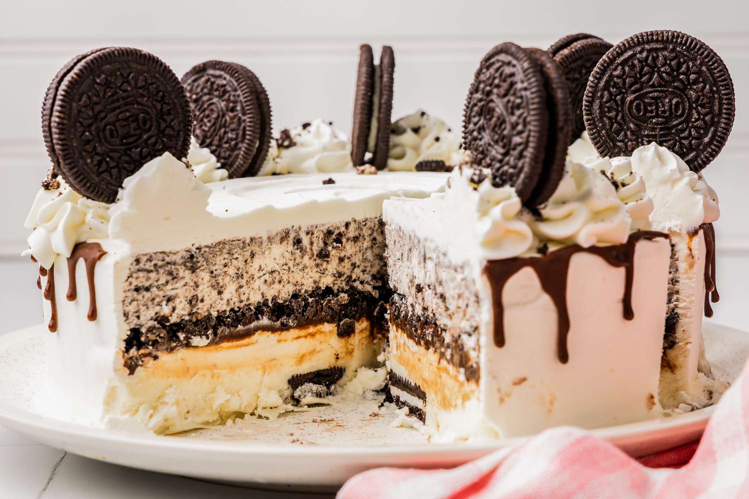 Plate of Oreo Ice Cream Cake With a Slice Cut Out 