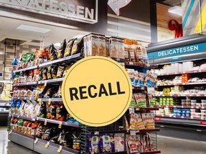 A grocery store aisle with a large recall sign overlaid