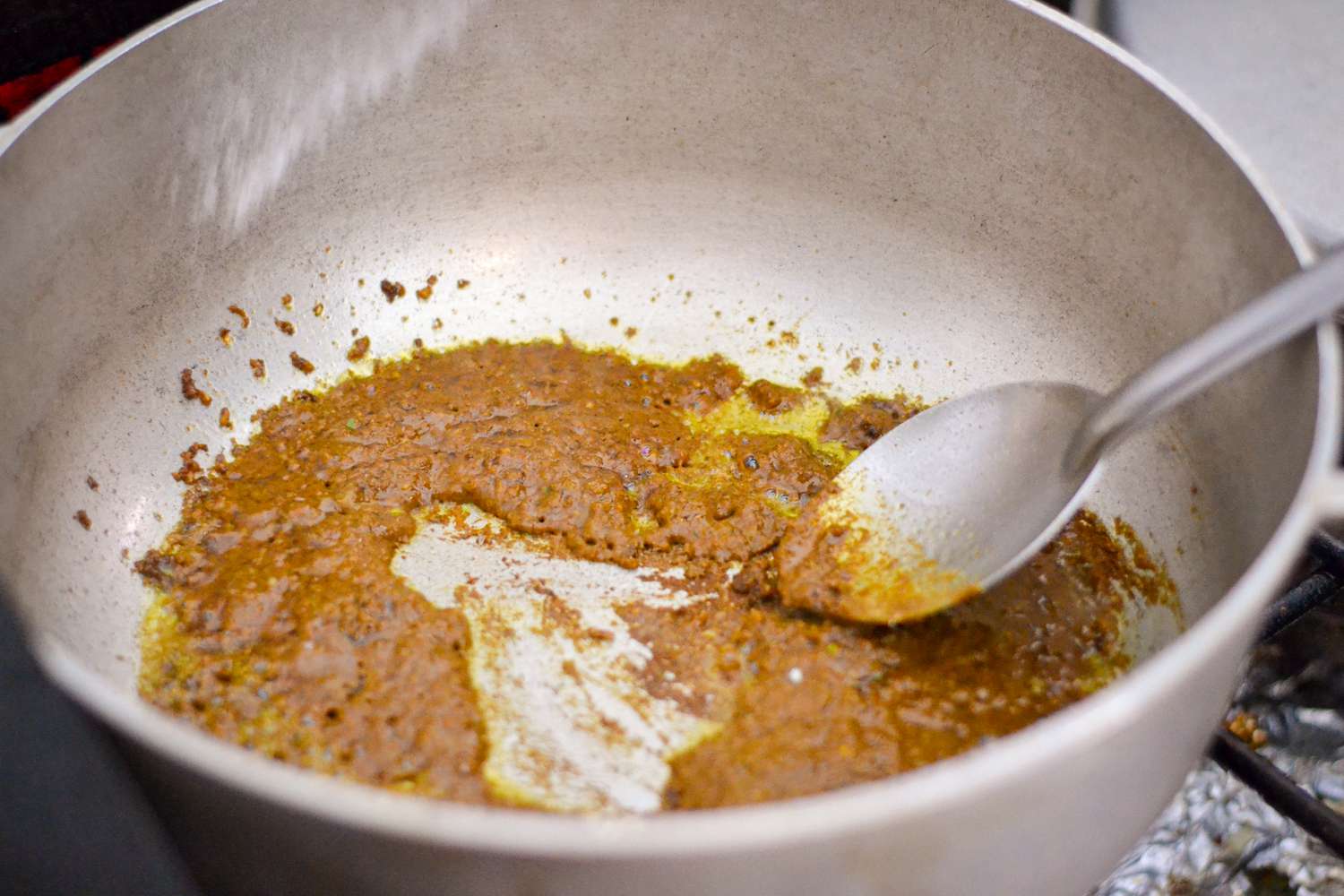Cook Curry Paste in Pot for Guyanese Chicken Curry