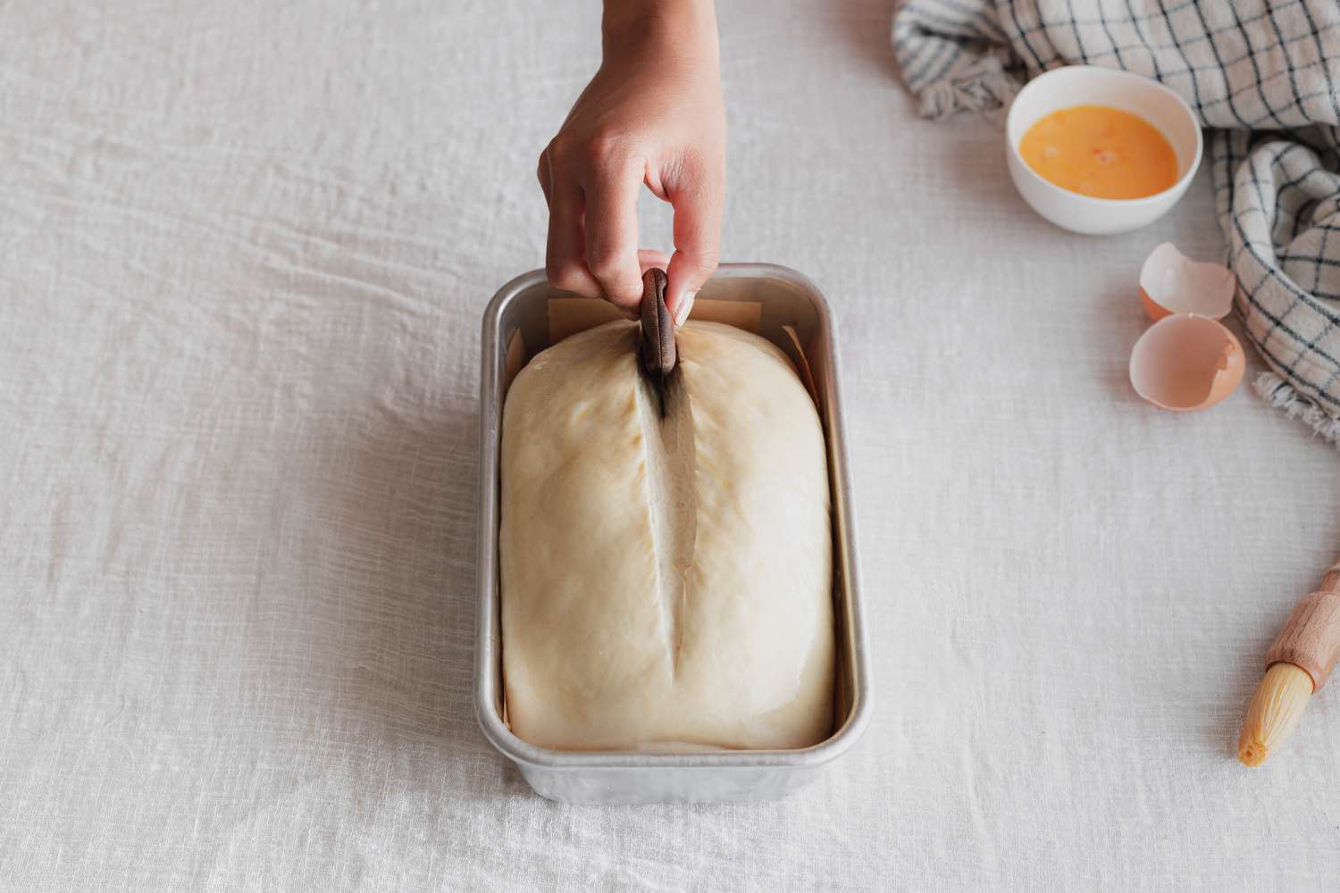 Lame Used to Score Sourdough Sandwich Loaf in a Baking Pan