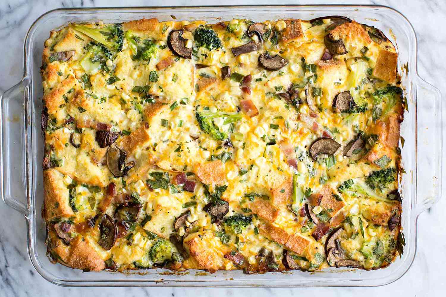 Breakfast Casserole with mushrooms and broccoli in a glass baking dish