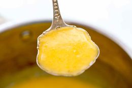 A ladle full of orange beurre blanc