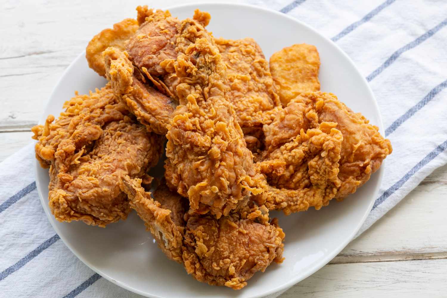 A plate of fried chicken served on a white plate
