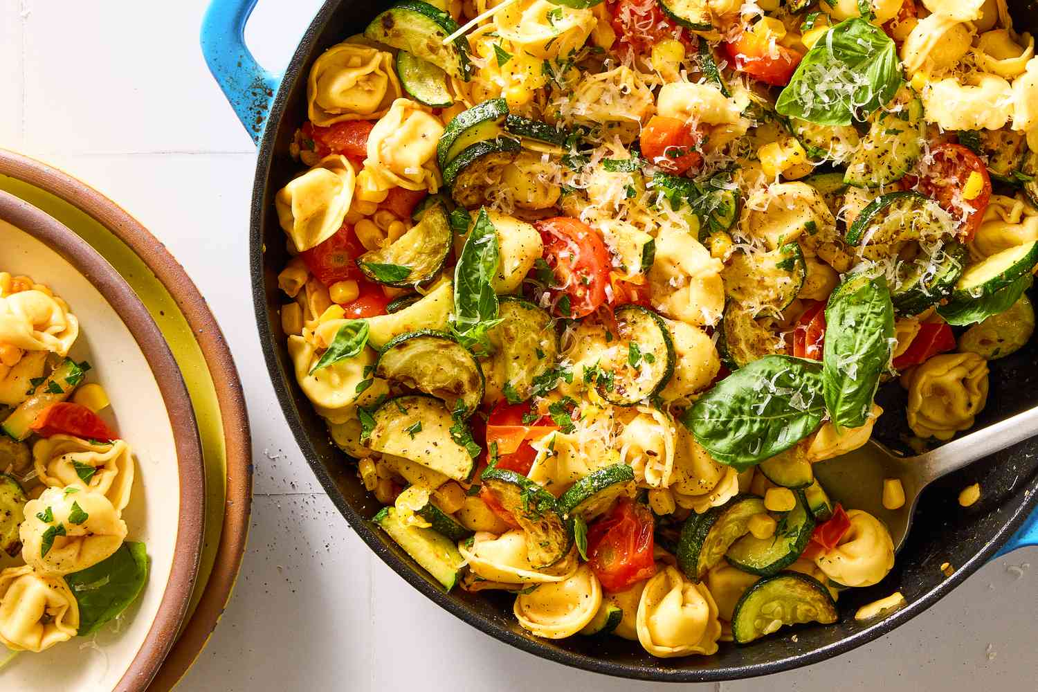 Skillet with tortellini, spinach, zucchini, and tomatoes