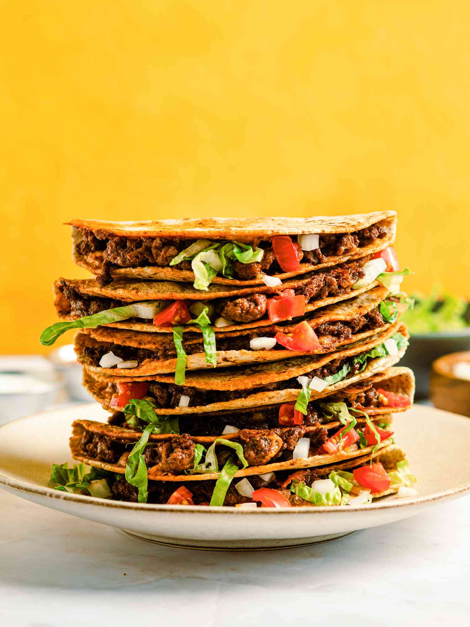 Stack of baked tacos on a plate