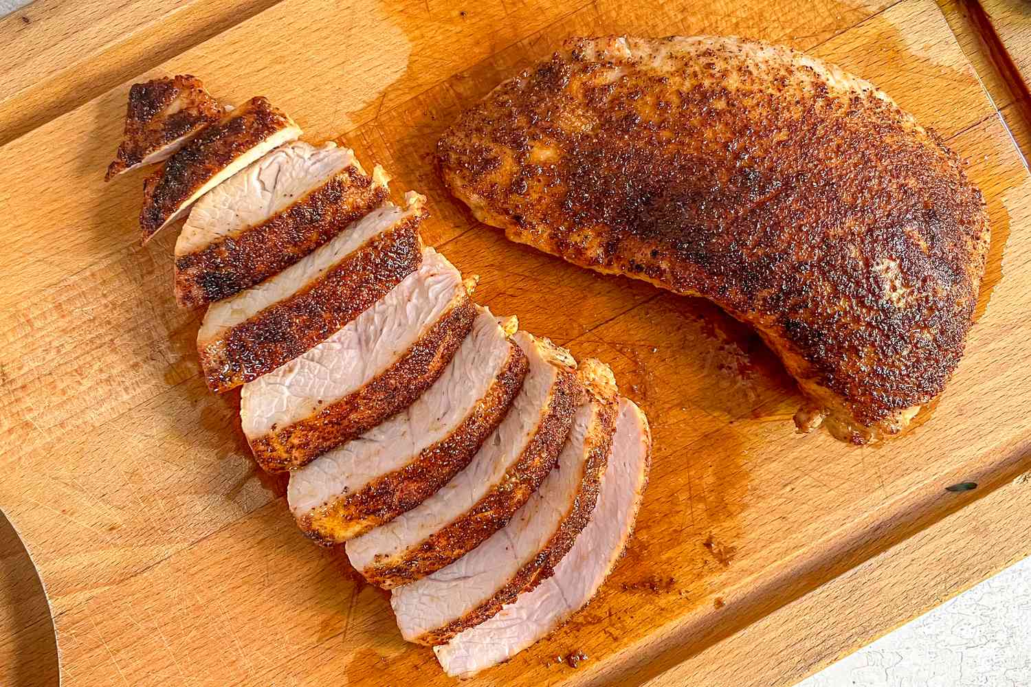 Turkey Tenderloin Cut into Slices on a Cutting Board