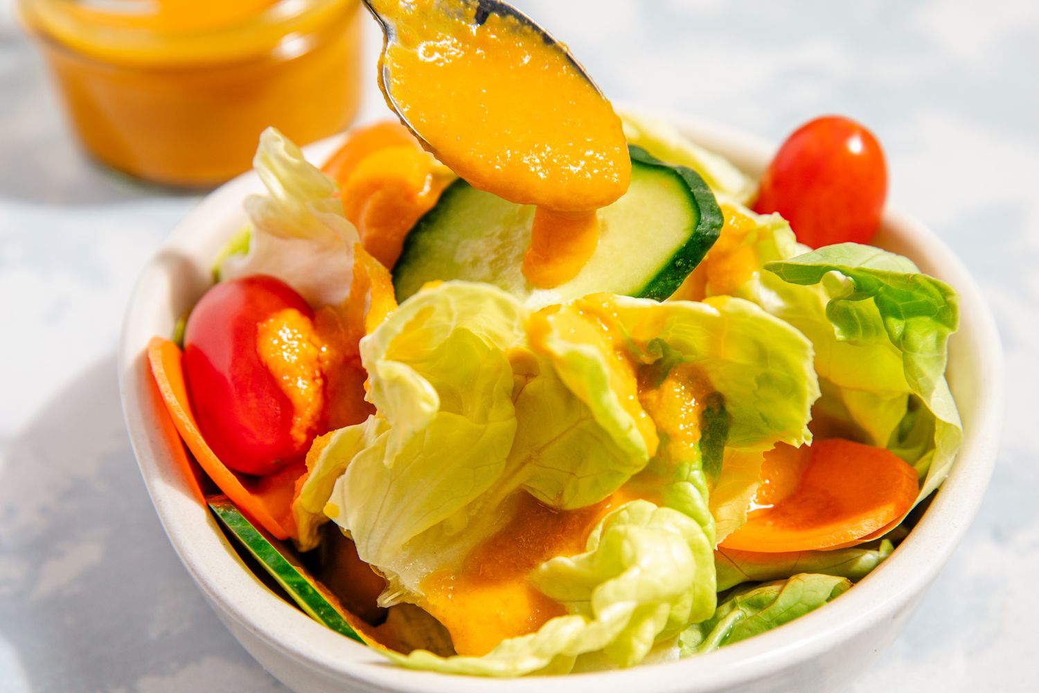 carrot ginger dressing added to a salad