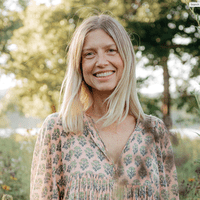 Kris Osborne wearing a light pink tunic with a flower pattern