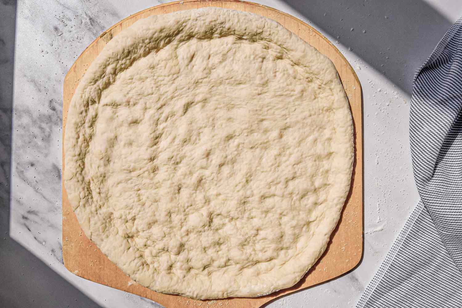 Pizza Dough Transferred Onto a Pizza Peel for Pizza Recipe