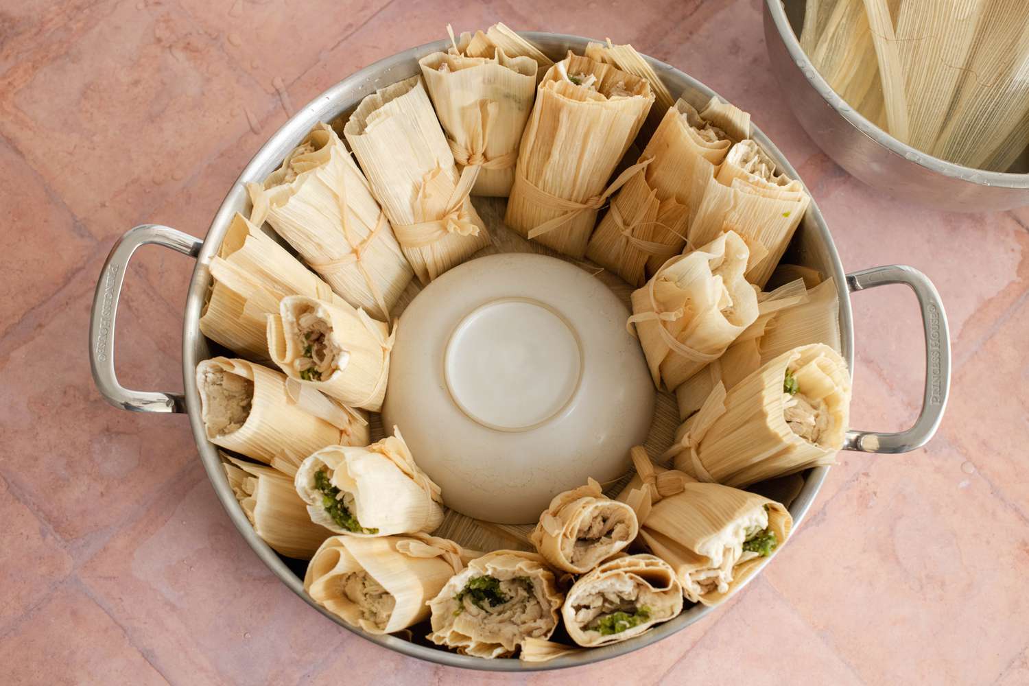 A Bowl Placed in the Middle of the Steamer and Tamales Placed around the Bowl in the Upright Position 