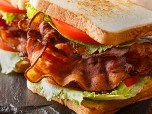 Closeup of a BLT sandwich with crispy bacon, tomato slices, lettuce, and toasted bread