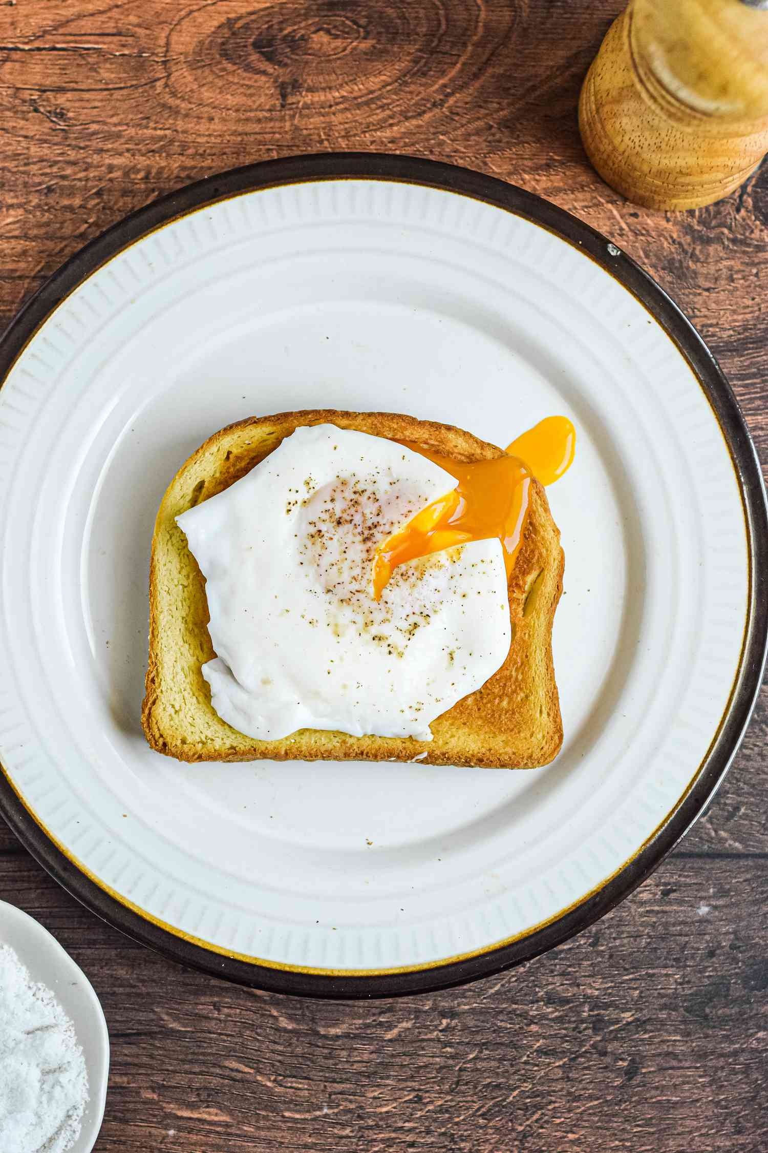 Overhead view of a poached egg on toast.