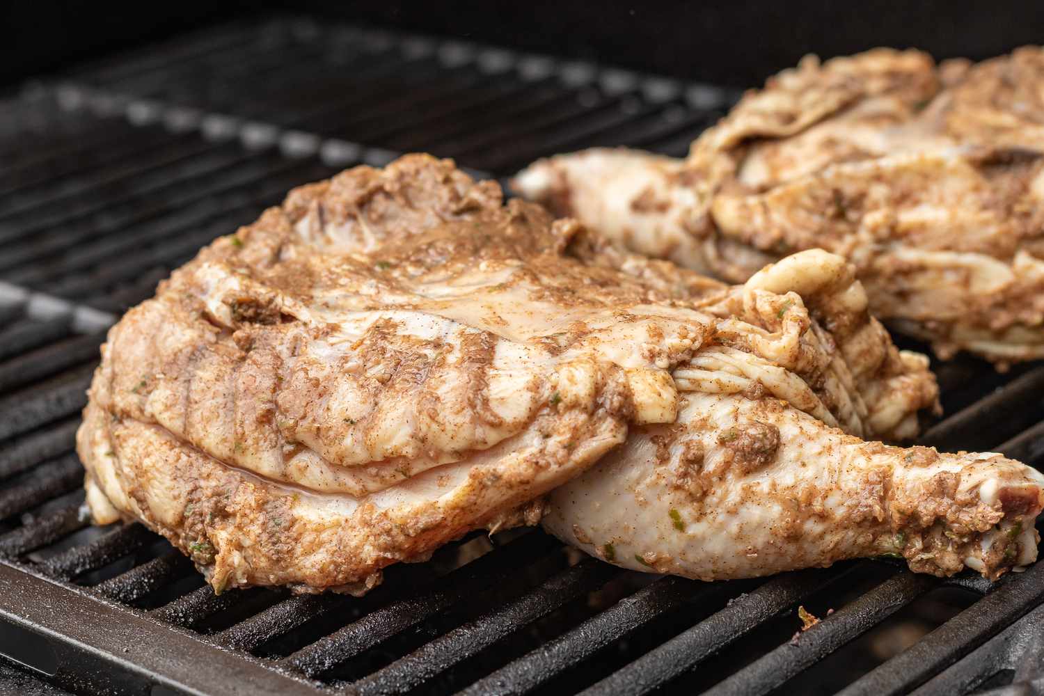 Chicken on the grill to make a jerk chicken recipe.