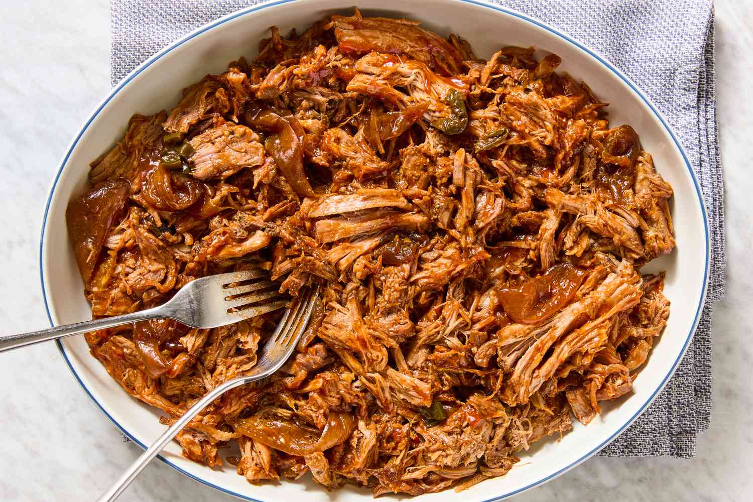 Texas-Style Pulled Pork in a large bowl with two forks