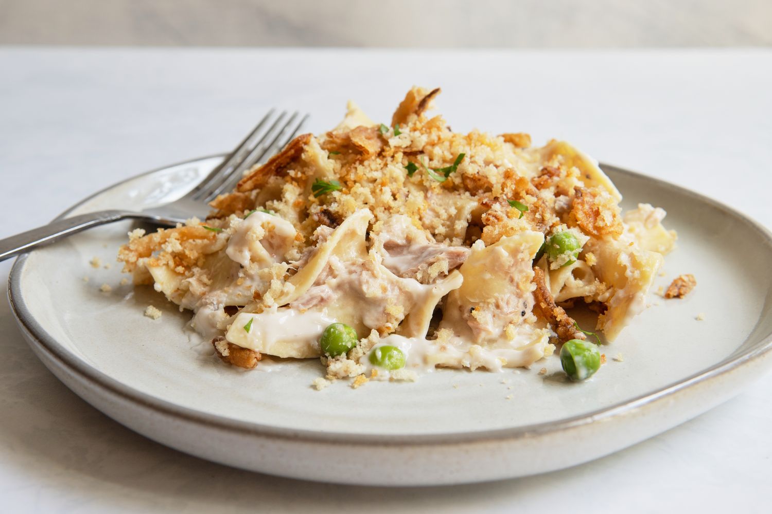 A plate of tuna noodle casserole with a fork resting on the side