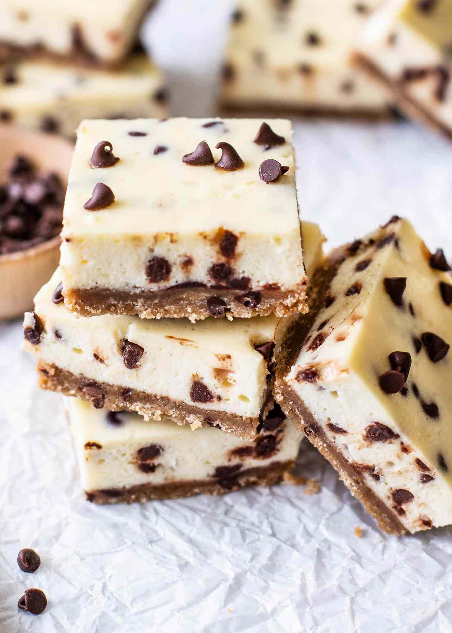 Chocolate Chip Cookie Cheesecake Bars stacked up in a small pile