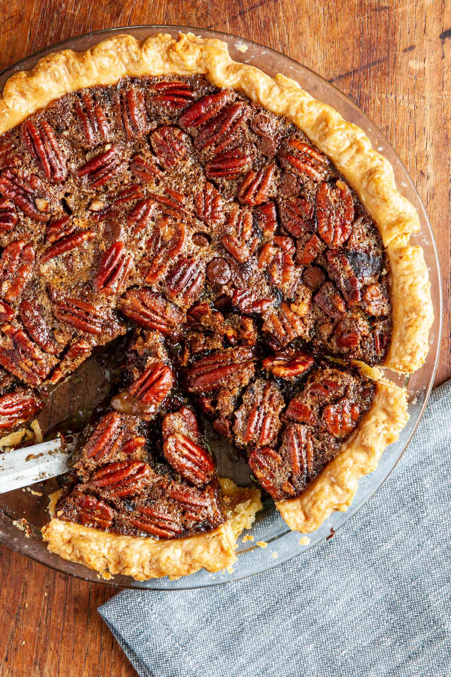 Chocolate pecan pie with bourbon with a couple slices cut.
