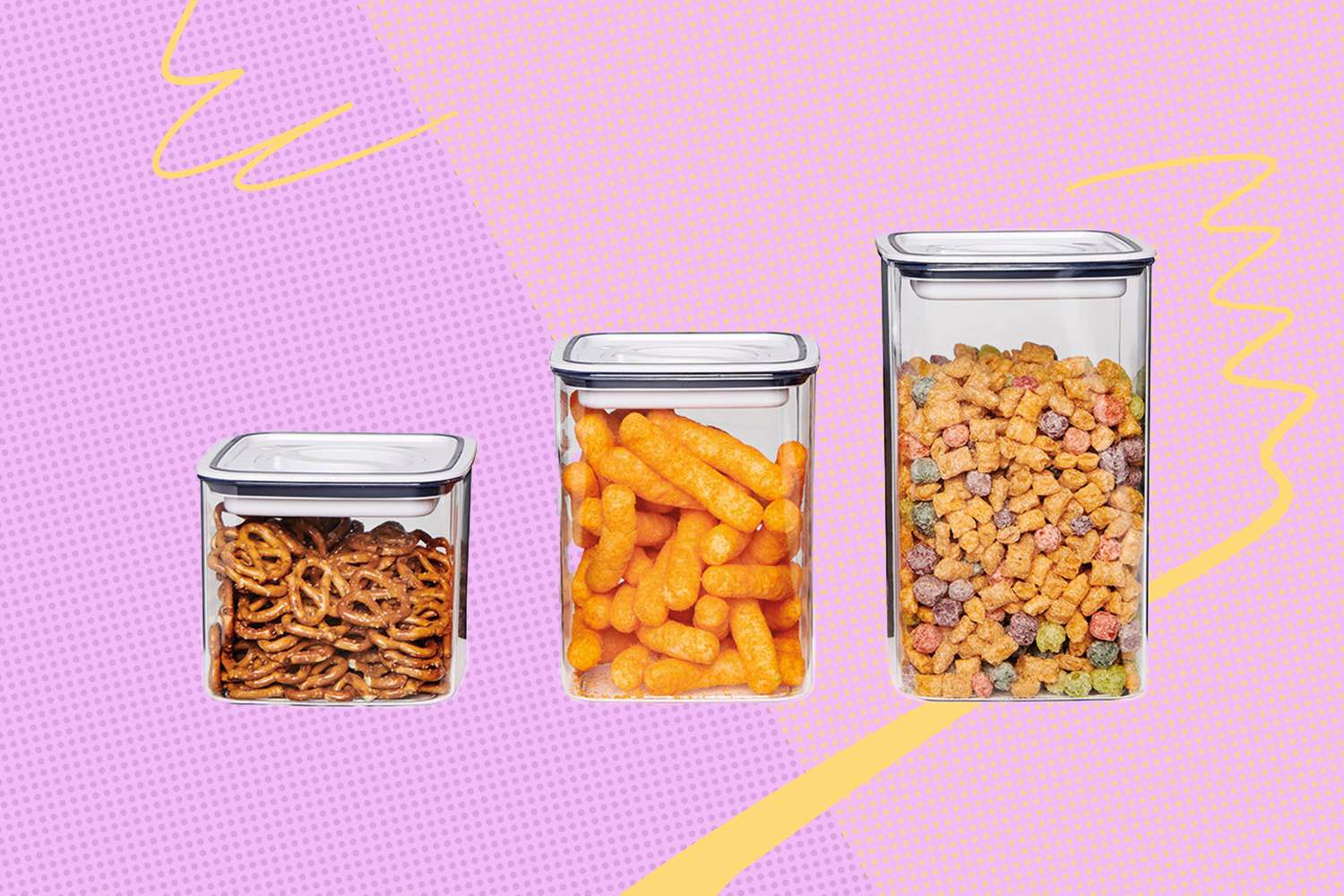 Three clear storage containers with lids containing pretzels cheese puffs and cereal placed on a colorful background