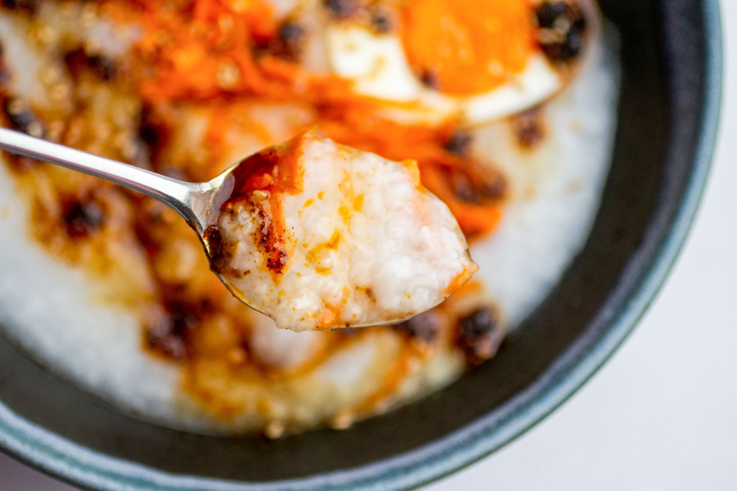 Spoon of jook with toppings