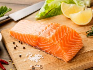 raw salmon fillet on a cutting board