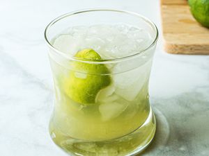 A rocks glass with a Brazilian caipirinha inside.
